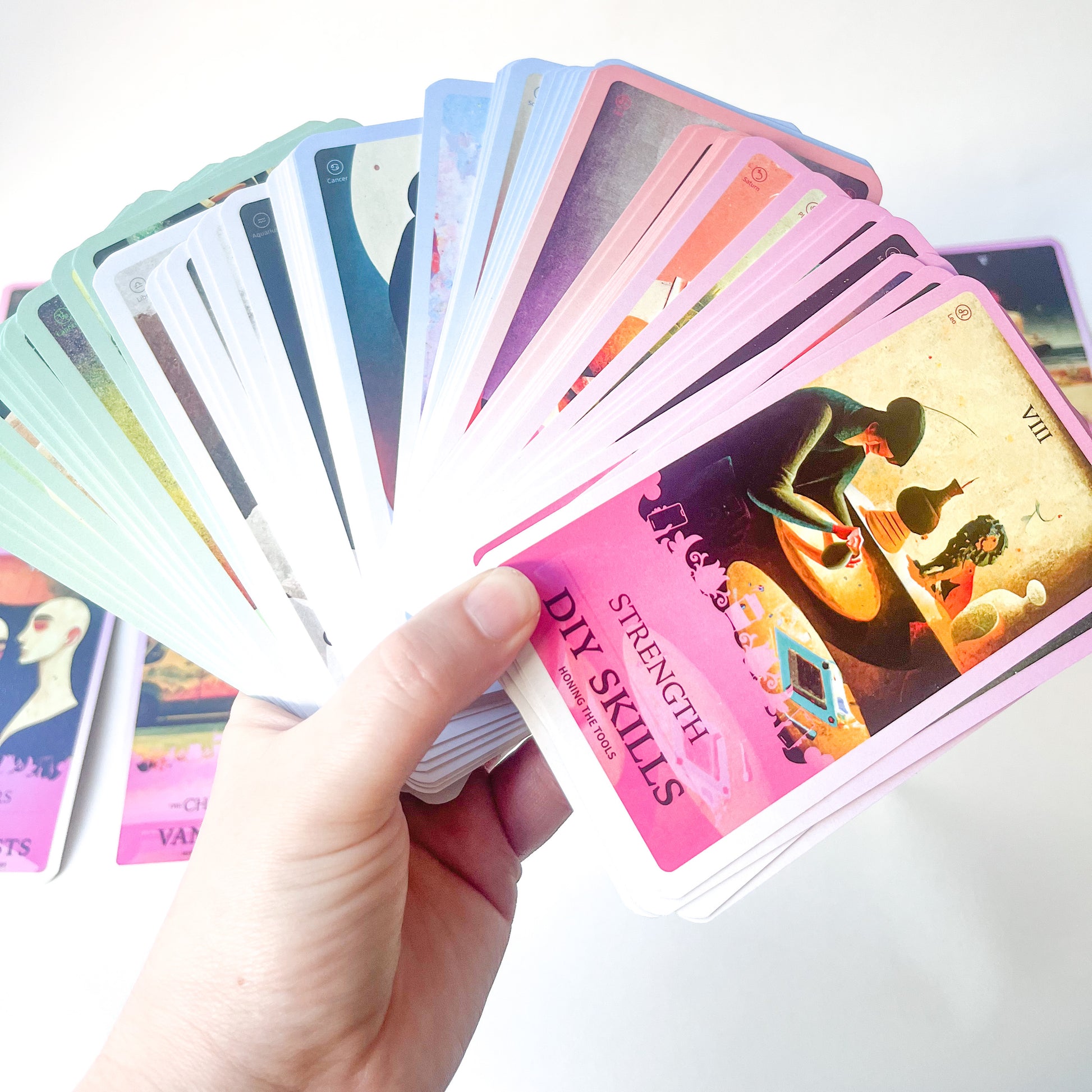 fanned image in a hand of the millennial tarot deck