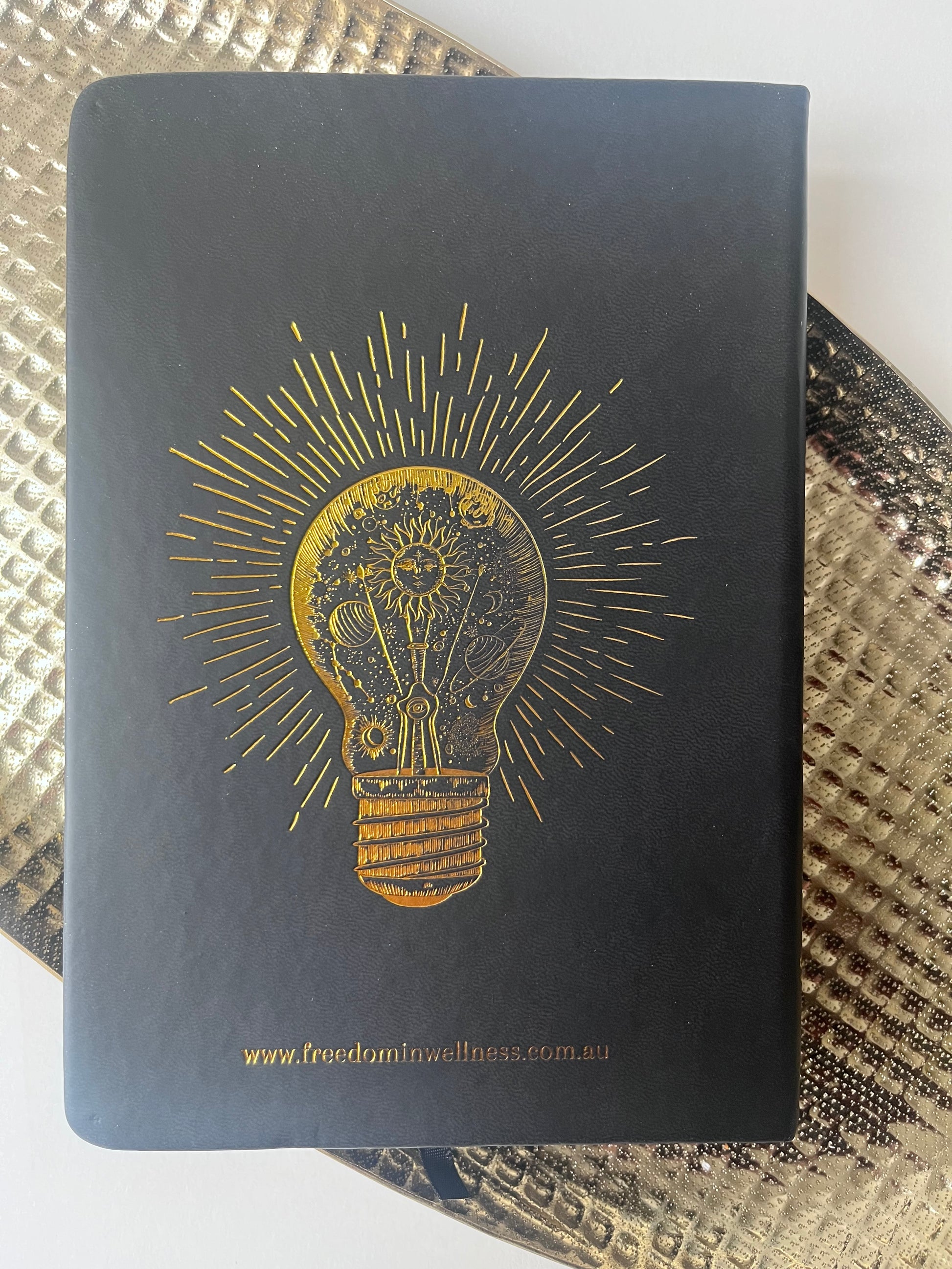 Leather Hardcover Manifesting Journal with image of lightbulb in gold foiling - backside