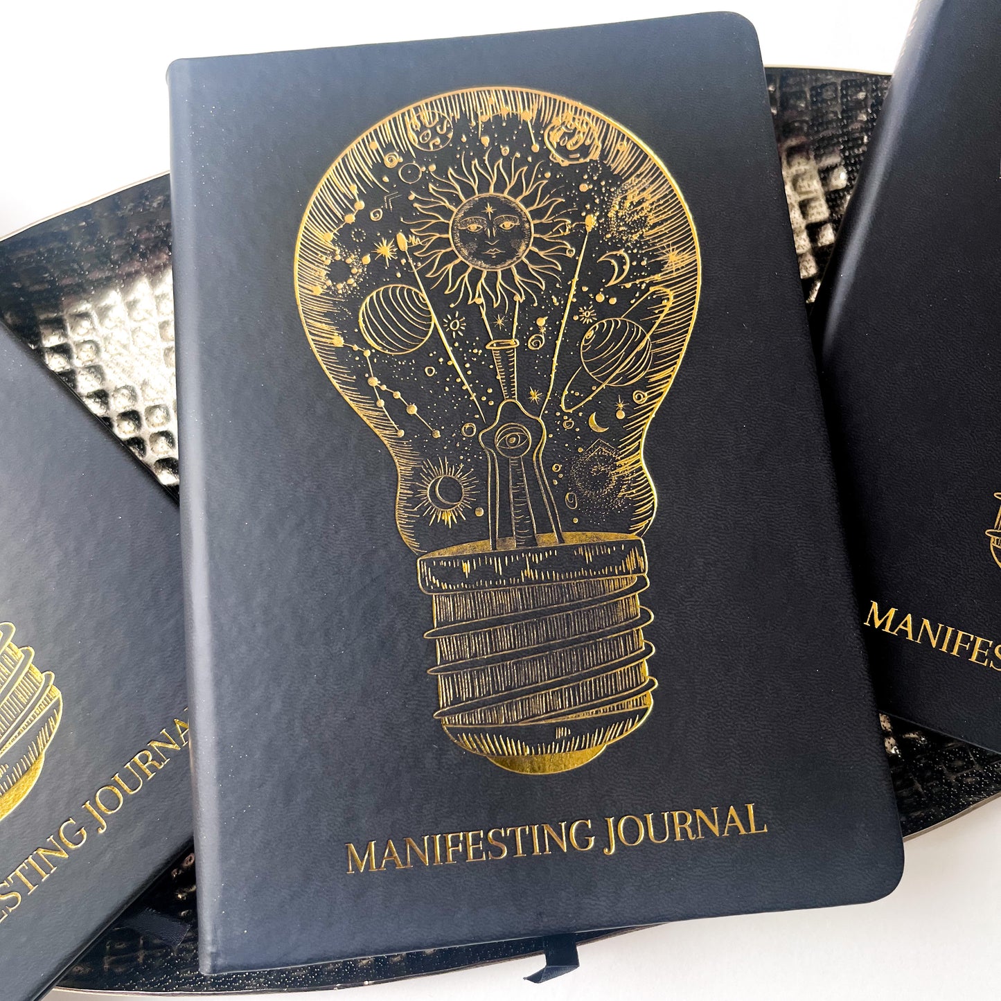 Leather Hardcover Manifesting Journal with image of lightbulb in gold foiling