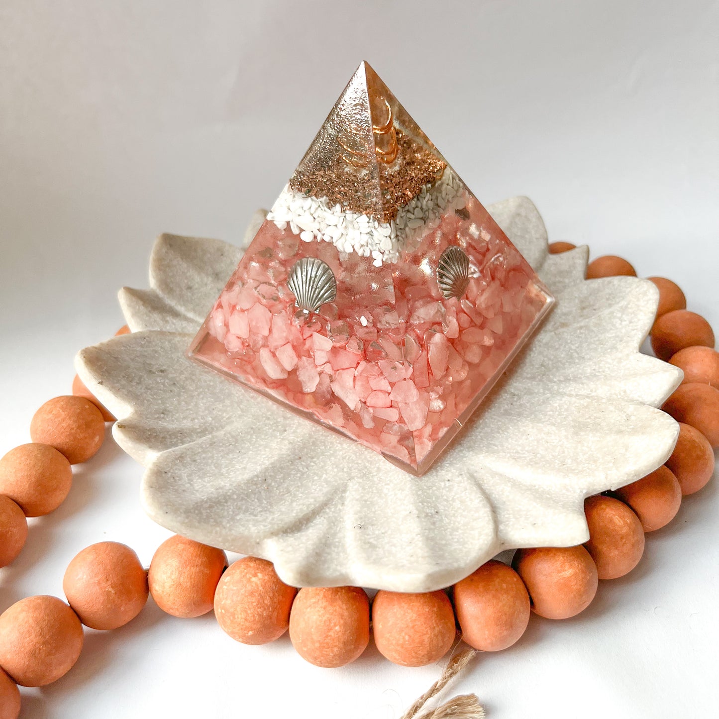 small orgonite pyramid with shells rose quartz and howlite