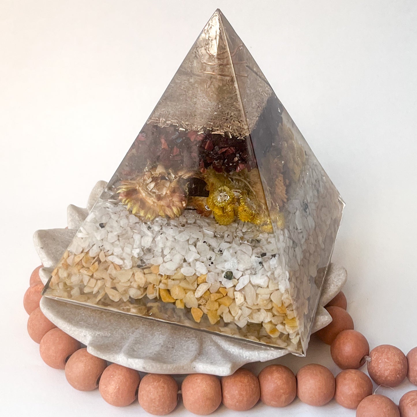 Beautifully crafted orgonite pyramid for meditation and relaxation with dried flowers