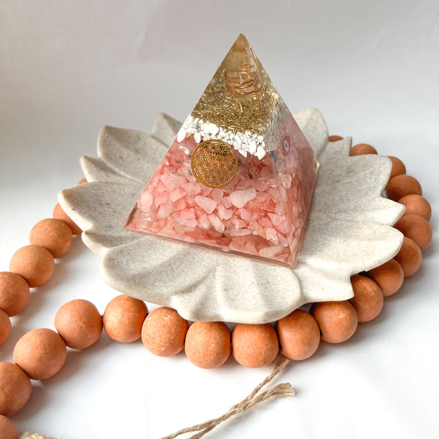 small rose quartz and howlite pyramid with evil eye